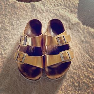 Women’s Birkenstock’s metallic gold Arizona sandal